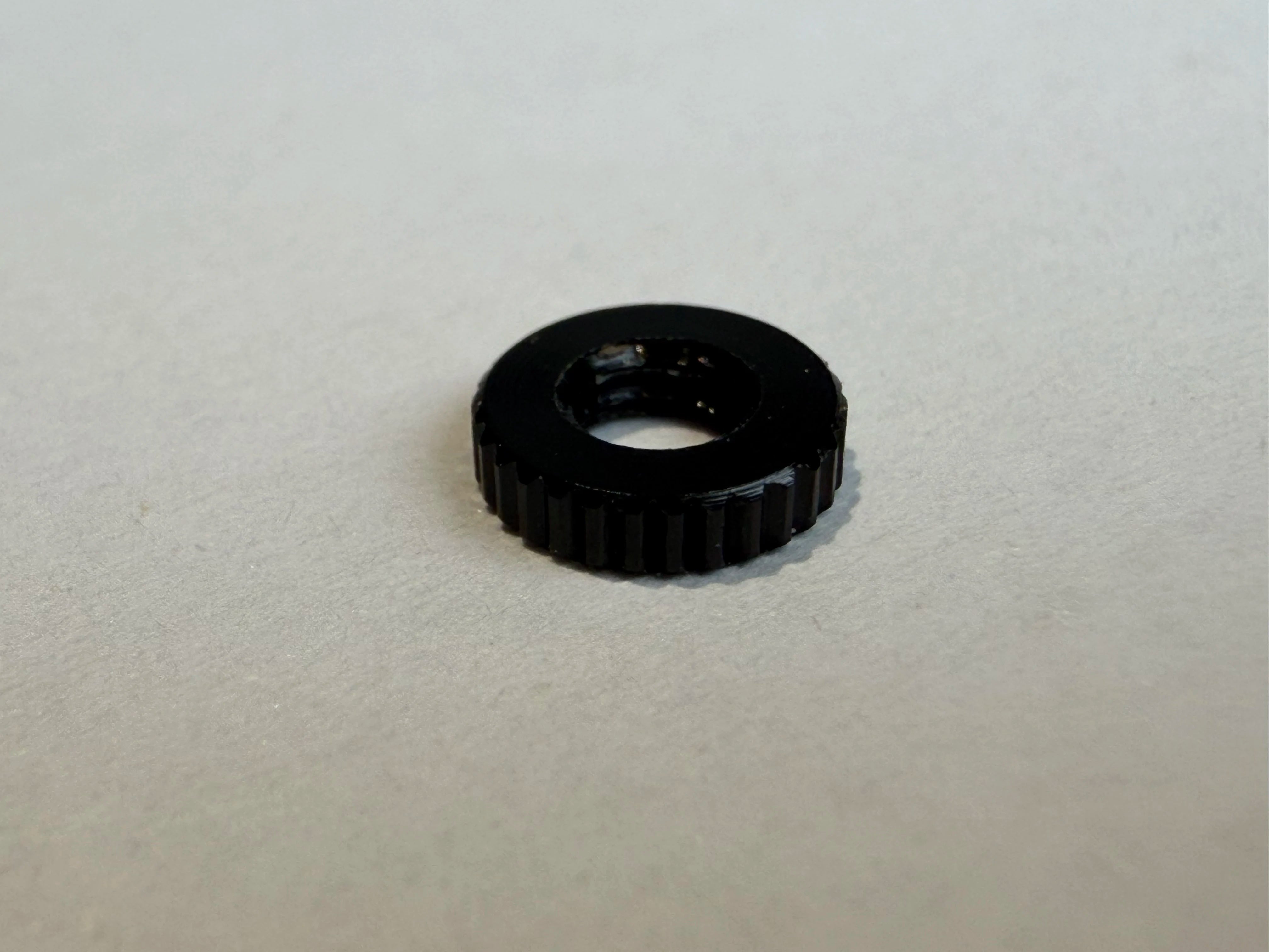 Single 1.5mm M3 aluminum FPV stack nut, anodized black knurled detail